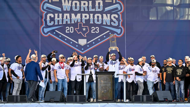 Texas Rangers starting pitcher Andrew Heaney raises the trophy during the celebration outside of the ballpark after the World Series championship parade at Globe Life Field.
